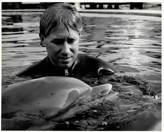 Bob Bailey working with a dolphin in the Navy’s Marine Mammal Program