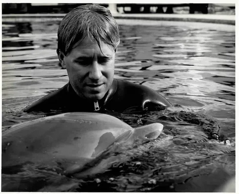 Bob Bailey working with a dolphin in the Navy’s Marine Mammal Program
